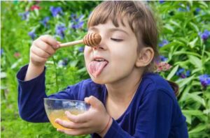 Child enjoying honey 